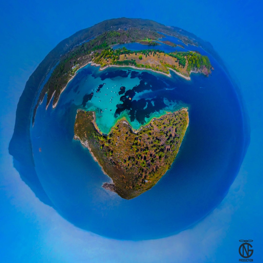 Tiny-planet 360° view of Blue Lagoon, Diaporos—turquoise shallows and sandbar between pine islets.