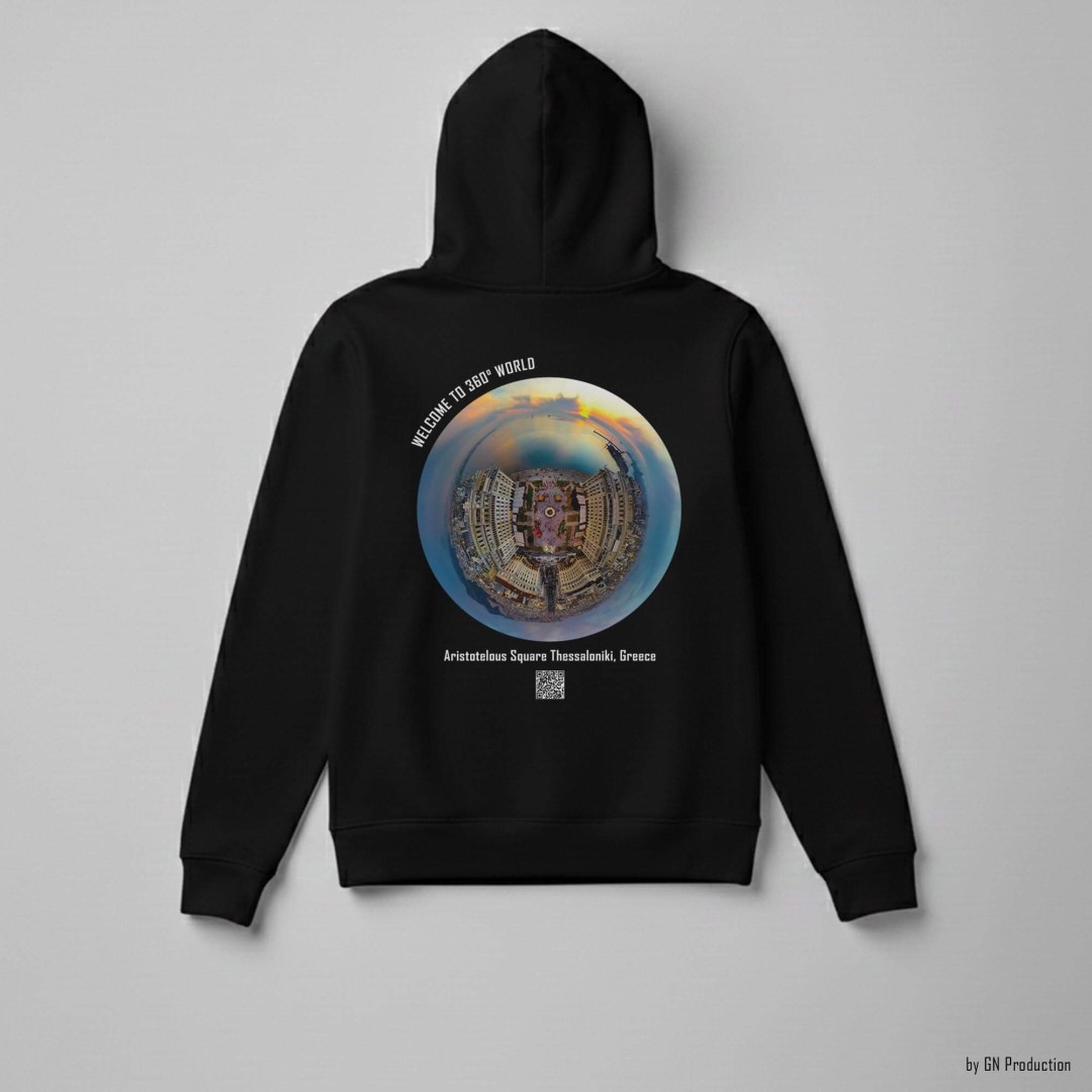 Black hoodie laid flat displaying Aristotelous Square Thessaloniki Christmas Edition golden-hour tiny-planet 360° artwork with warm festive glow and coastal skyline details.