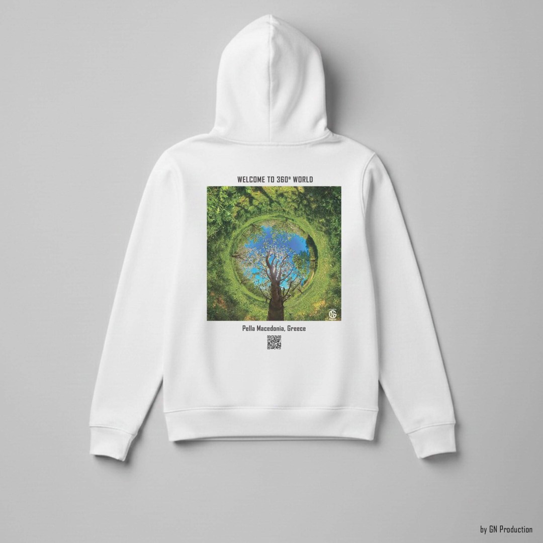 White GN Production hoodie flat lay, back view showing Pella cherry orchard inverted tiny-planet 360° artwork with blossom ring and blue sky, Greece.