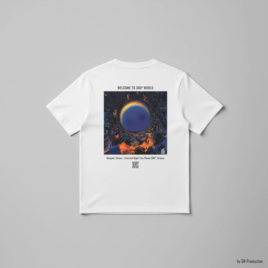 White art T-shirt flat lay with inverted-night tiny-planet 360° print of Ilioupoli, Athens, showcasing amber streetlights and dark blue sky.