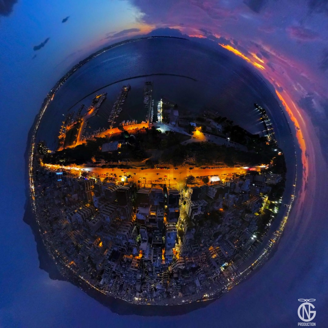 Aretsou Marina, Thessaloniki at dusk — night drone tiny-planet 360° with amber streetlights and seafront.