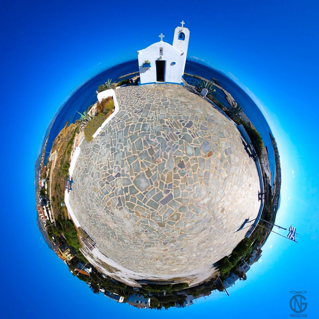 Tiny-planet 360° view of Saint Nicholas Church above Rafina’s harbor—stone promenade, Greek flag waving, bright Aegean light.