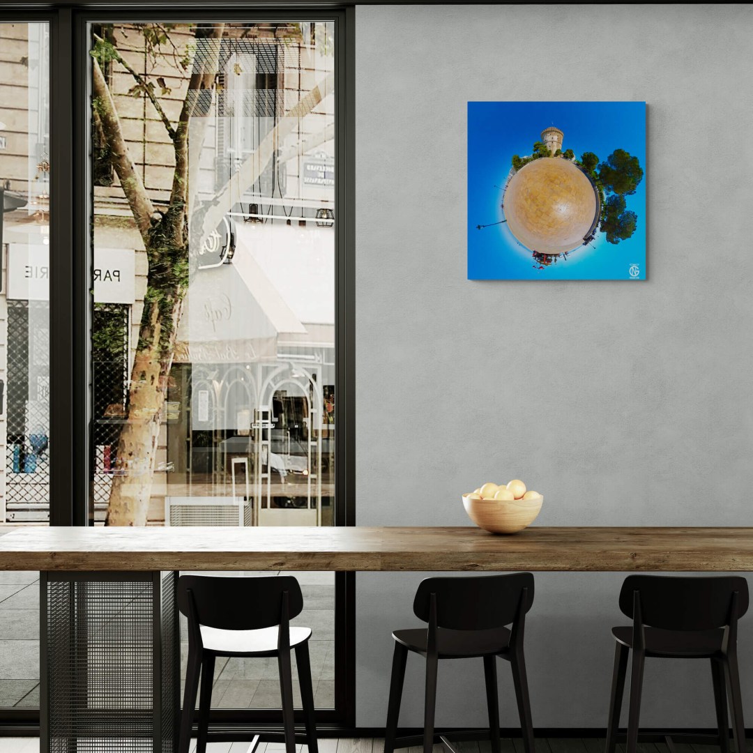 White Tower tiny-planet canvas on a café wall beside window seating.