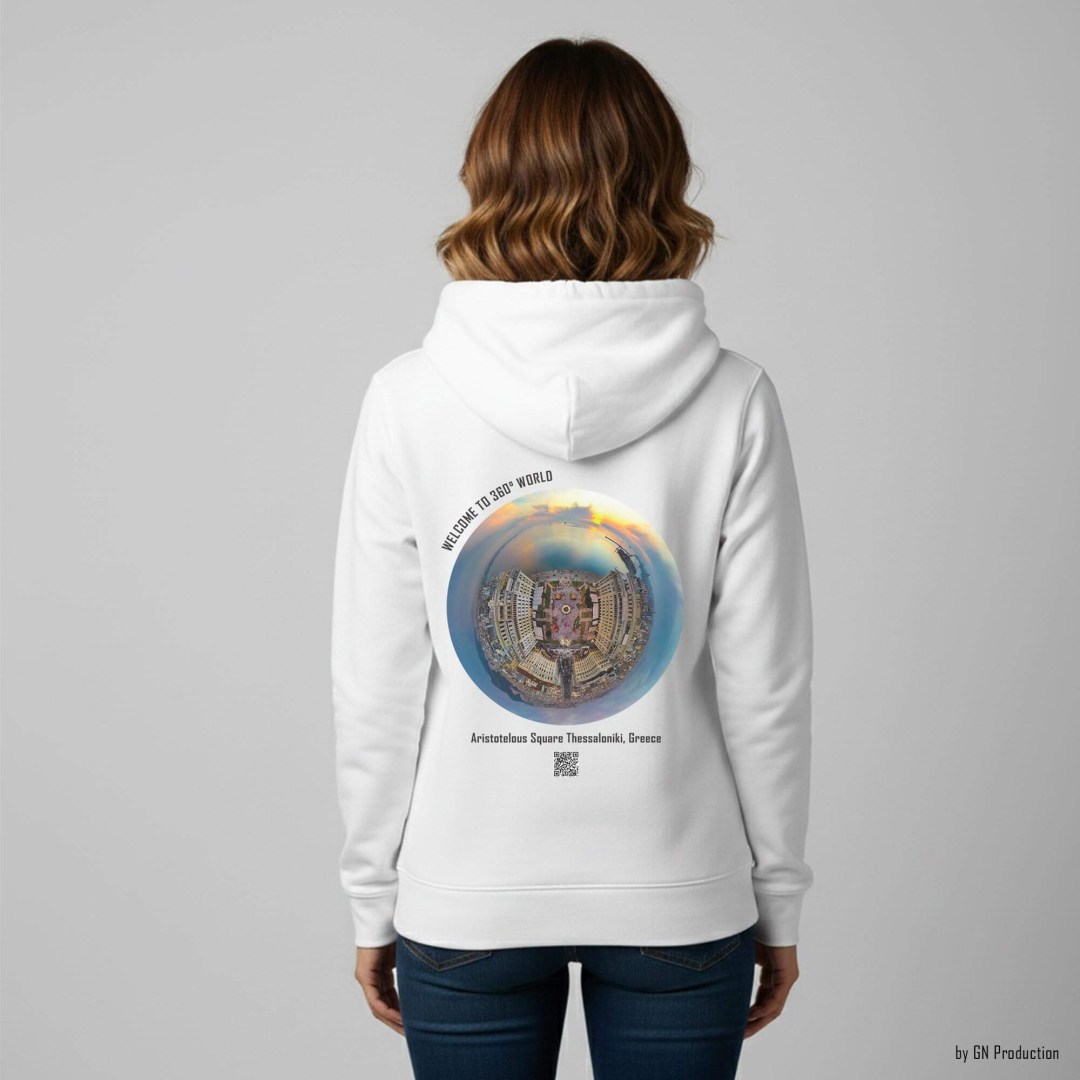 Woman wearing a white GN Production hoodie featuring Aristotelous Square, Thessaloniki in a Christmas Edition golden-hour tiny-planet 360° drone shot, with festive city lights and Thermaic Gulf horizon on the back.