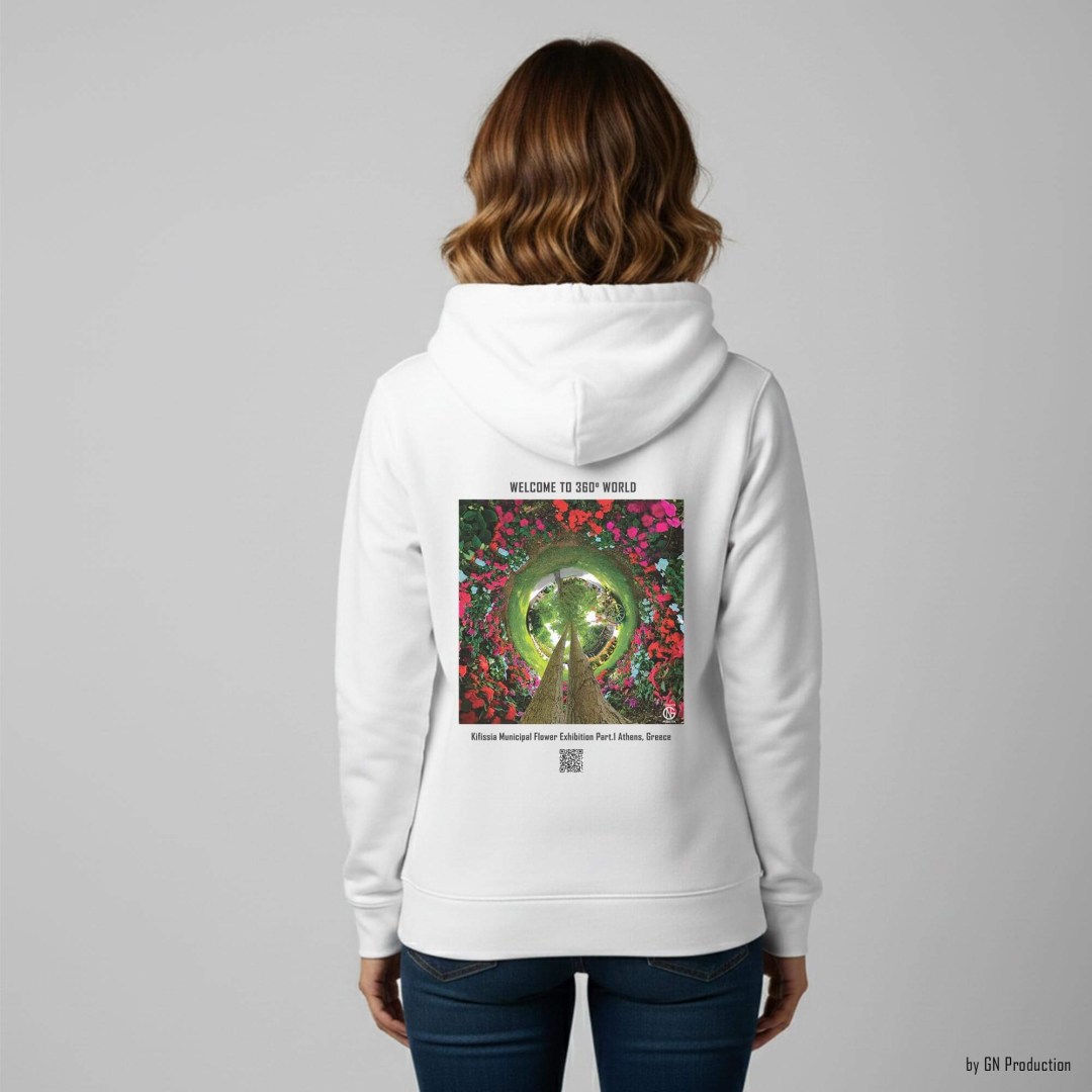 Woman wearing white 360° floral art hoodie, back view, featuring Kifissia Municipal Flower Exhibition inverted tiny-planet (Eros Part I), vivid red and pink blooms surrounding twin tree trunks, Handmade in Greece by GN Production.