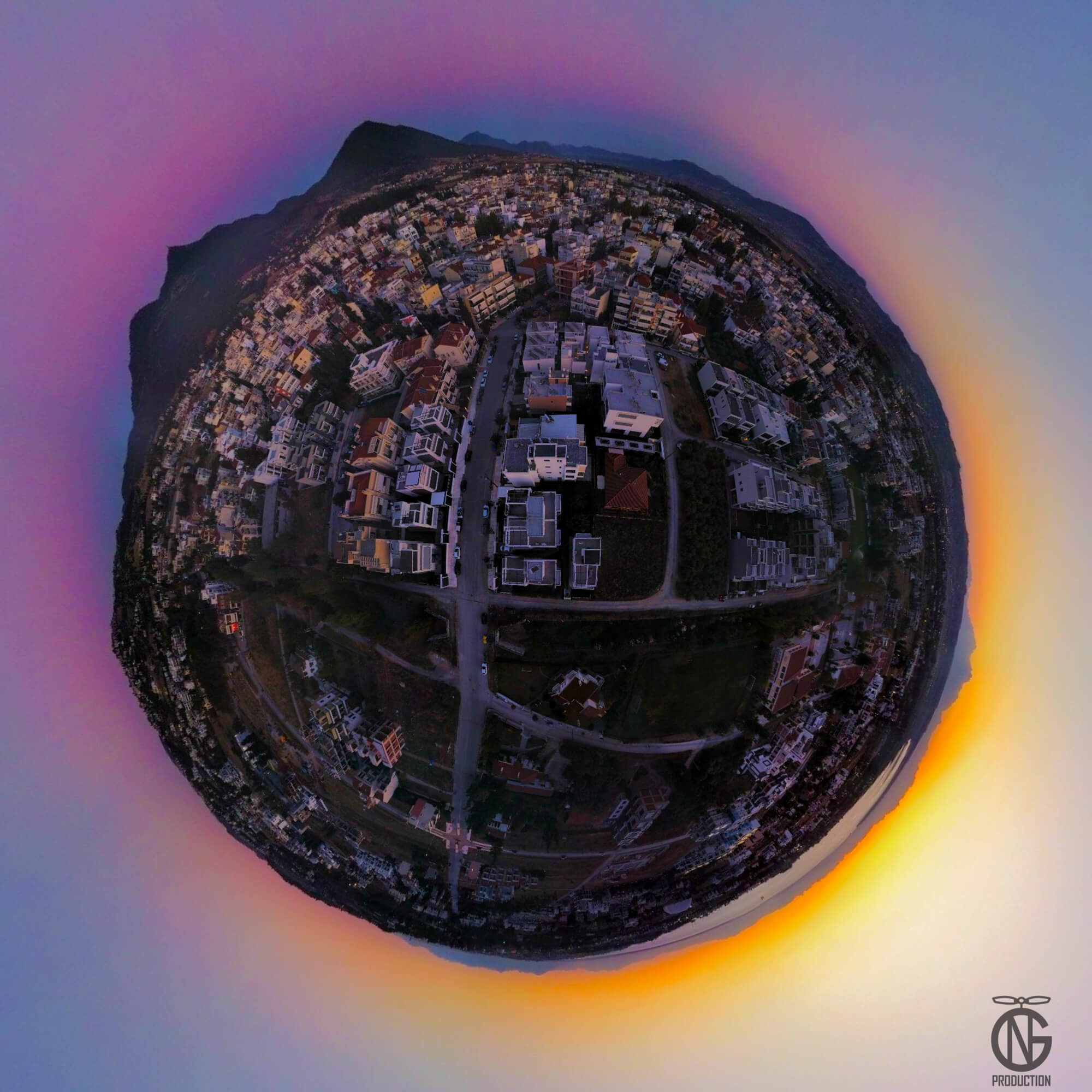 Sunset tiny-planet 360° drone view of Thermi: warm golden horizon ring around a violet-blue sky over the city.